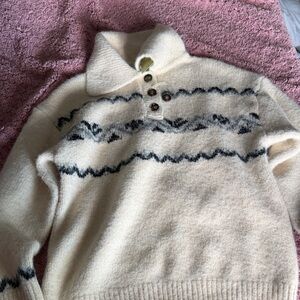 Elegant Cream Turtleneck Sweater with Black Patterns